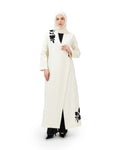 Woman wearing a white abaya with black floral patterns on a white background asain style